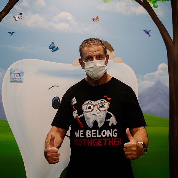 Young Woman Smiling By Green Wall
