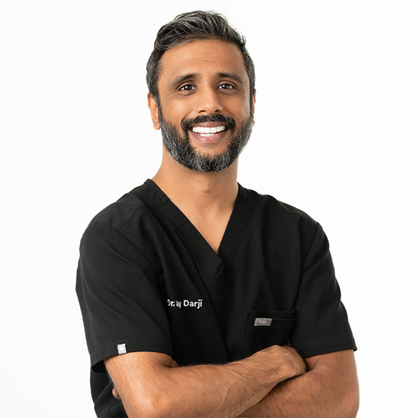 Young Woman Smiling By Green Wall